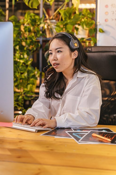 Executive Assistant For Startup Founders And CEOs Working On PC With Headphones