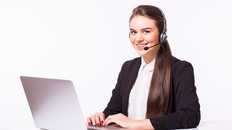 Executive hospitality virtual assistant wearing a headset and working on a laptop